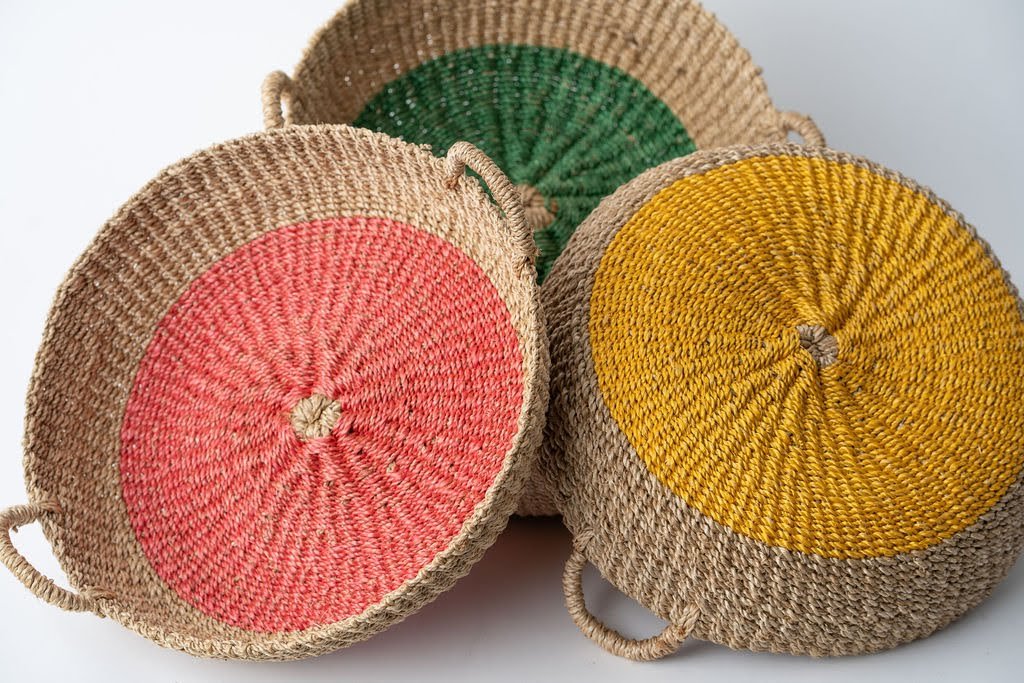 Iris Round Tray I Olive, a handwoven seagrass tray with vibrant yellow circular design, perfect for serving or organizing.