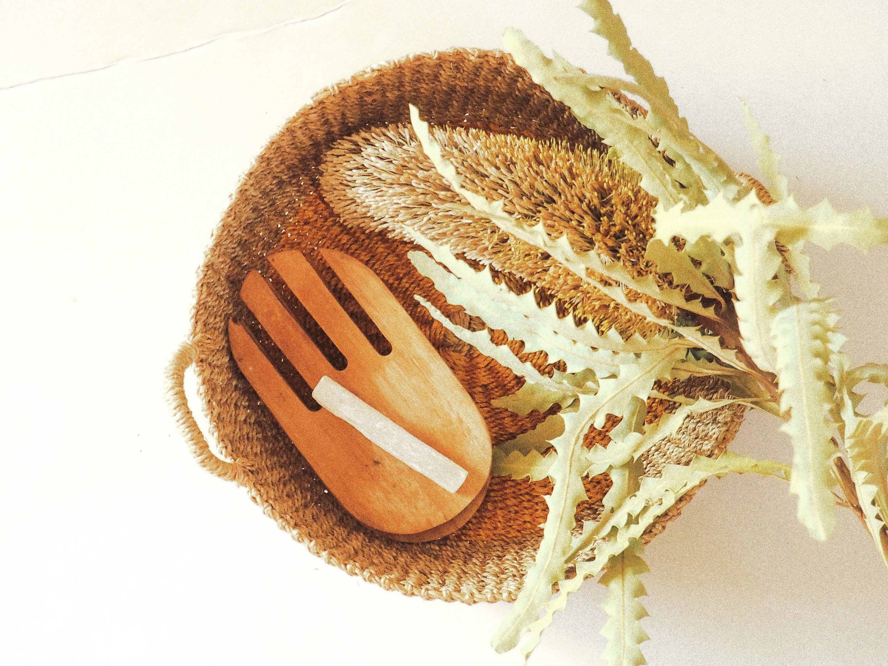 Iris Round Tray I Olive, a handwoven seagrass tray with vibrant yellow circular design, perfect for serving or organizing.