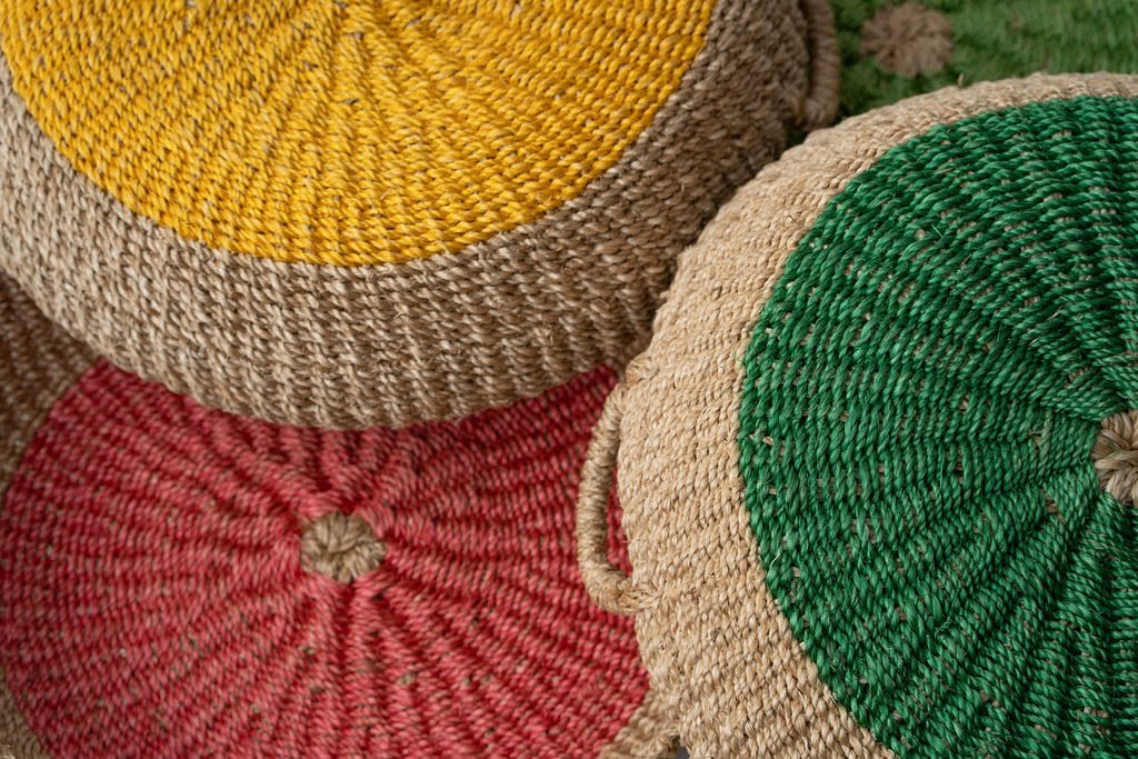 Iris Round Tray I Olive, a handwoven seagrass tray with vibrant yellow circular design, perfect for serving or organizing.