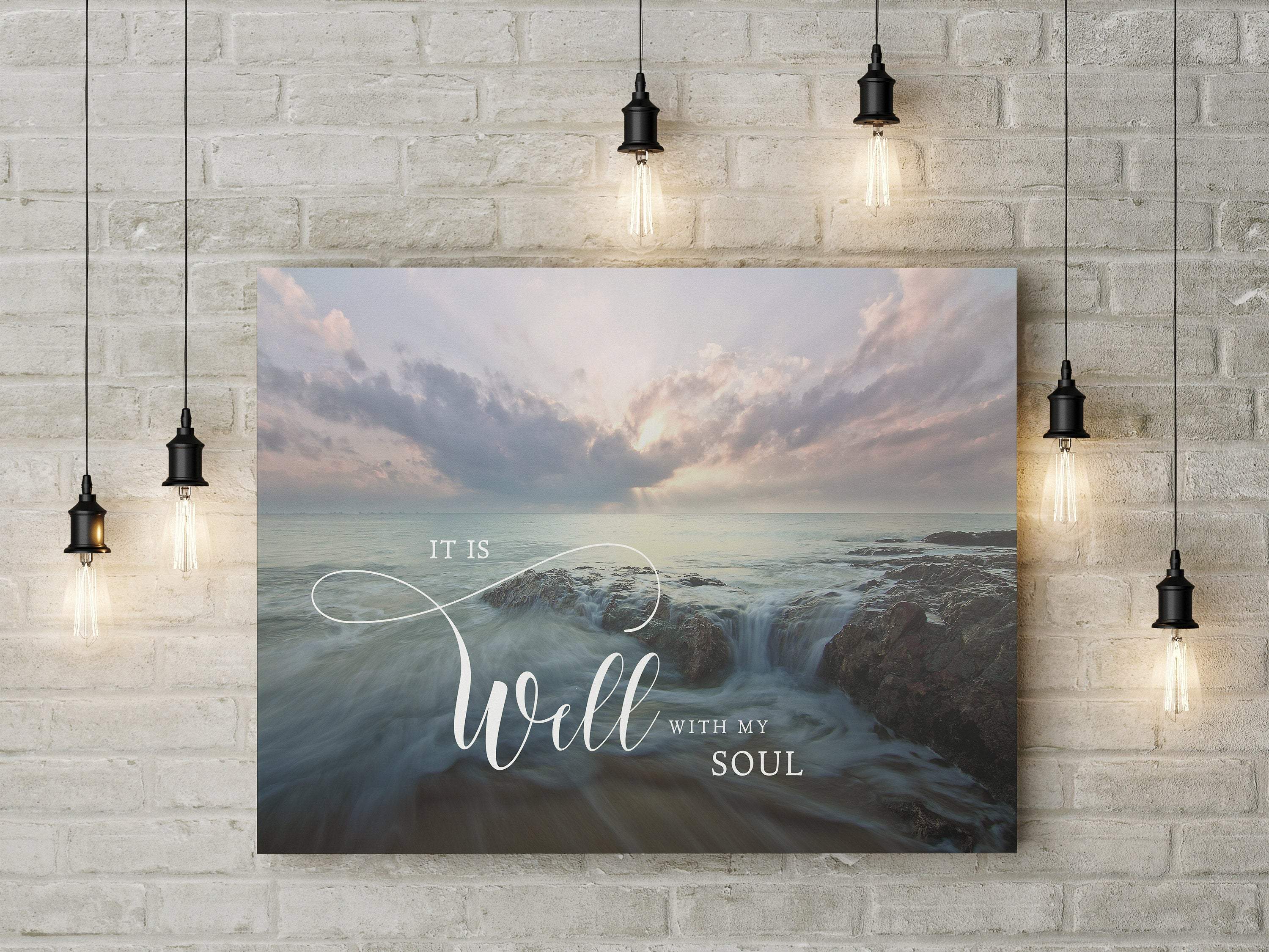 A serene canvas print featuring the quote 'It Is Well With My Soul' under a beautiful sky and peaceful waters, perfect for home decor.