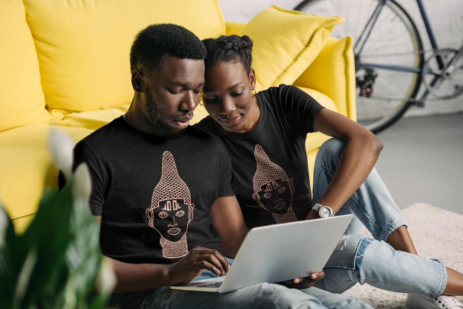 IYOBA Art Tee featuring rose-gold prints of Queen IDIA on a black background, made from 100% organic cotton.