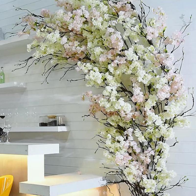 A beautiful arrangement of Japanese Sakura artificial flowers in pink and white, showcasing their realistic silk petals and abundant blooms.