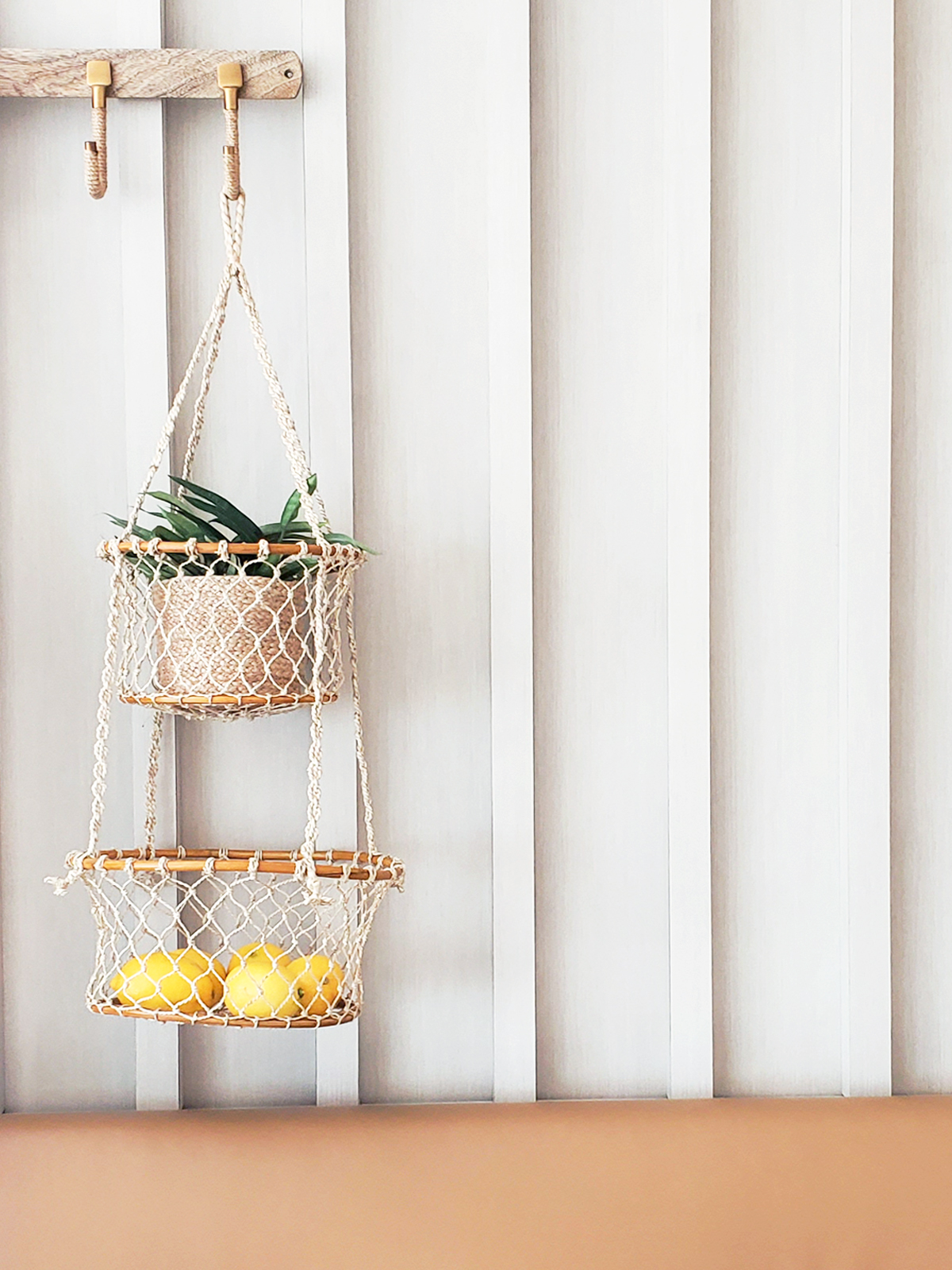 Jhuri Double Hanging Basket made from natural jute and wood, featuring two baskets for plants or storage, showcasing rustic charm.