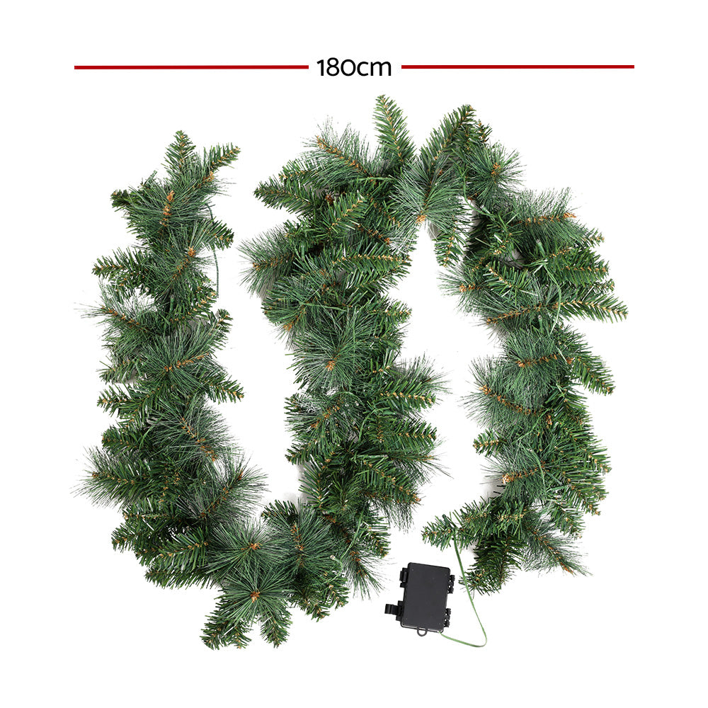 Jingle Jollys 1.8M Christmas Garland with warm LED lights, showcasing thick foliage and a festive design.