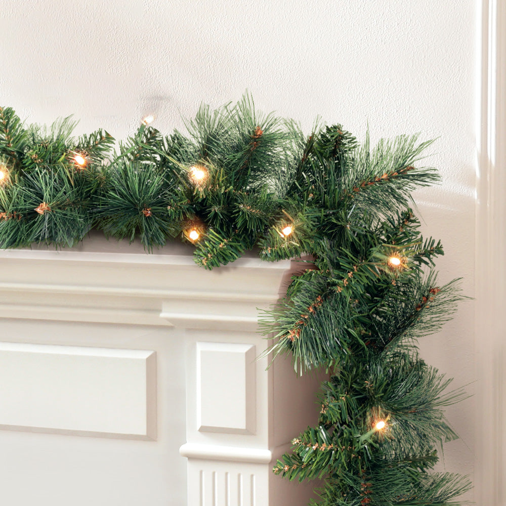 Jingle Jollys 1.8M Christmas Garland with warm LED lights, showcasing thick foliage and a festive design.