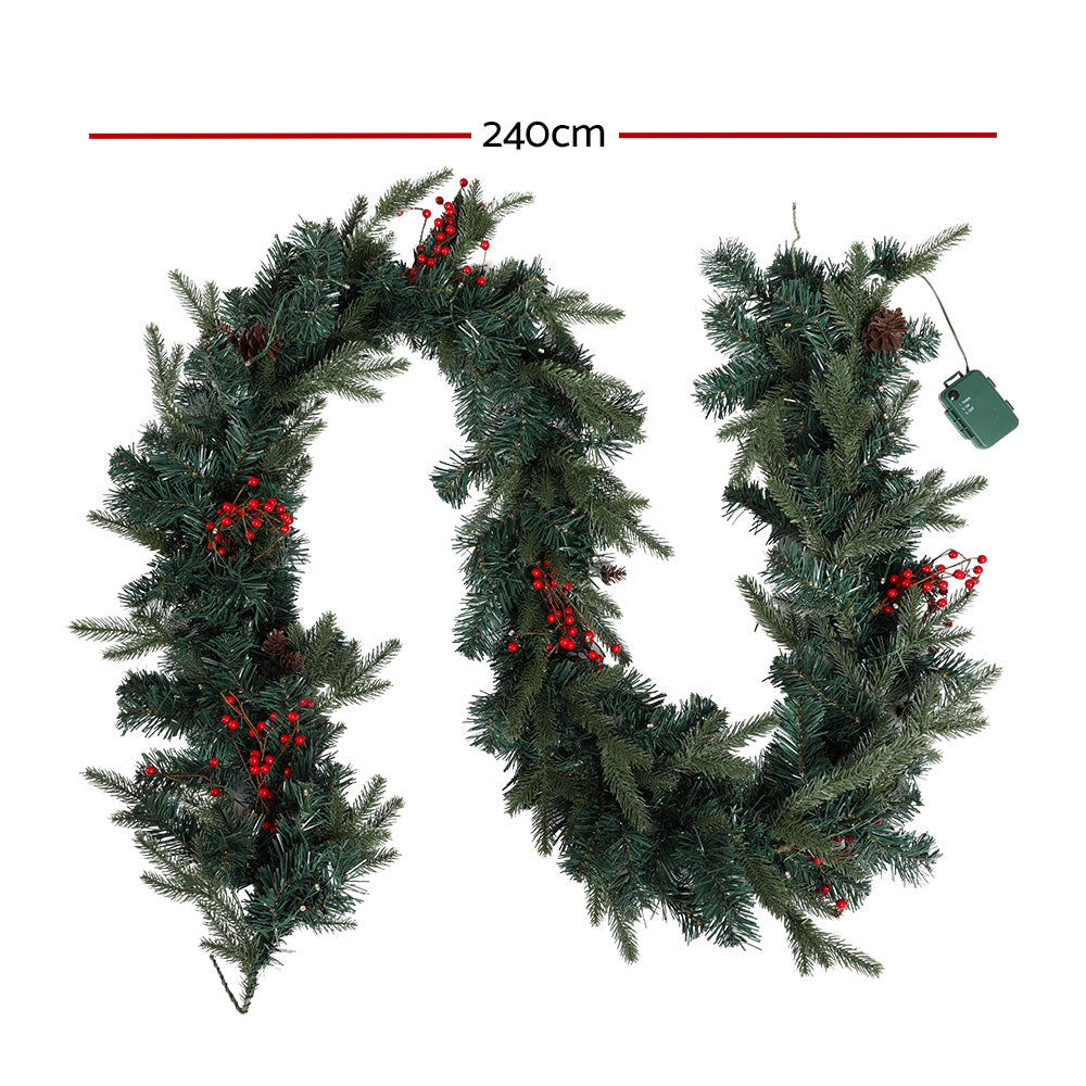 Jingle Jollys 2.4M Christmas Garland with warm LED lights, artificial berries, and pinecones, perfect for festive decoration.