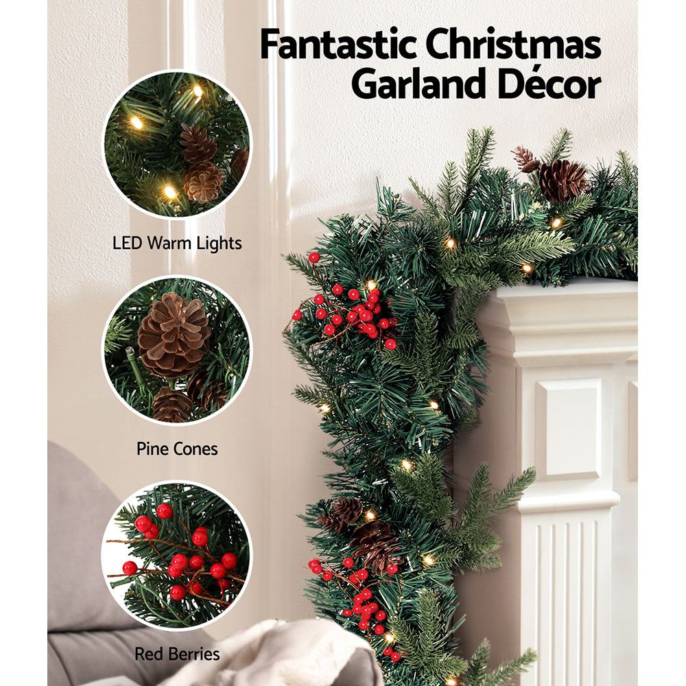 Jingle Jollys 2.4M Christmas Garland with warm LED lights, artificial berries, and pinecones, perfect for festive decoration.