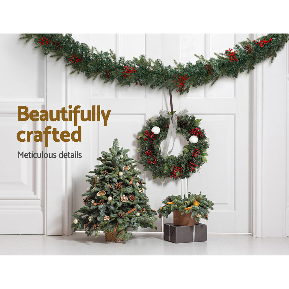 Jingle Jollys 2.4M Christmas Garland with warm LED lights, artificial berries, and pinecones, perfect for festive decoration.