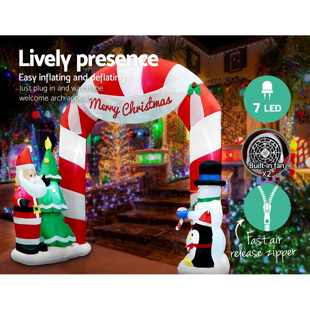 Jingle Jollys 3M Christmas Inflatable Archway featuring Santa, snowman, and penguin, illuminated with LED lights.