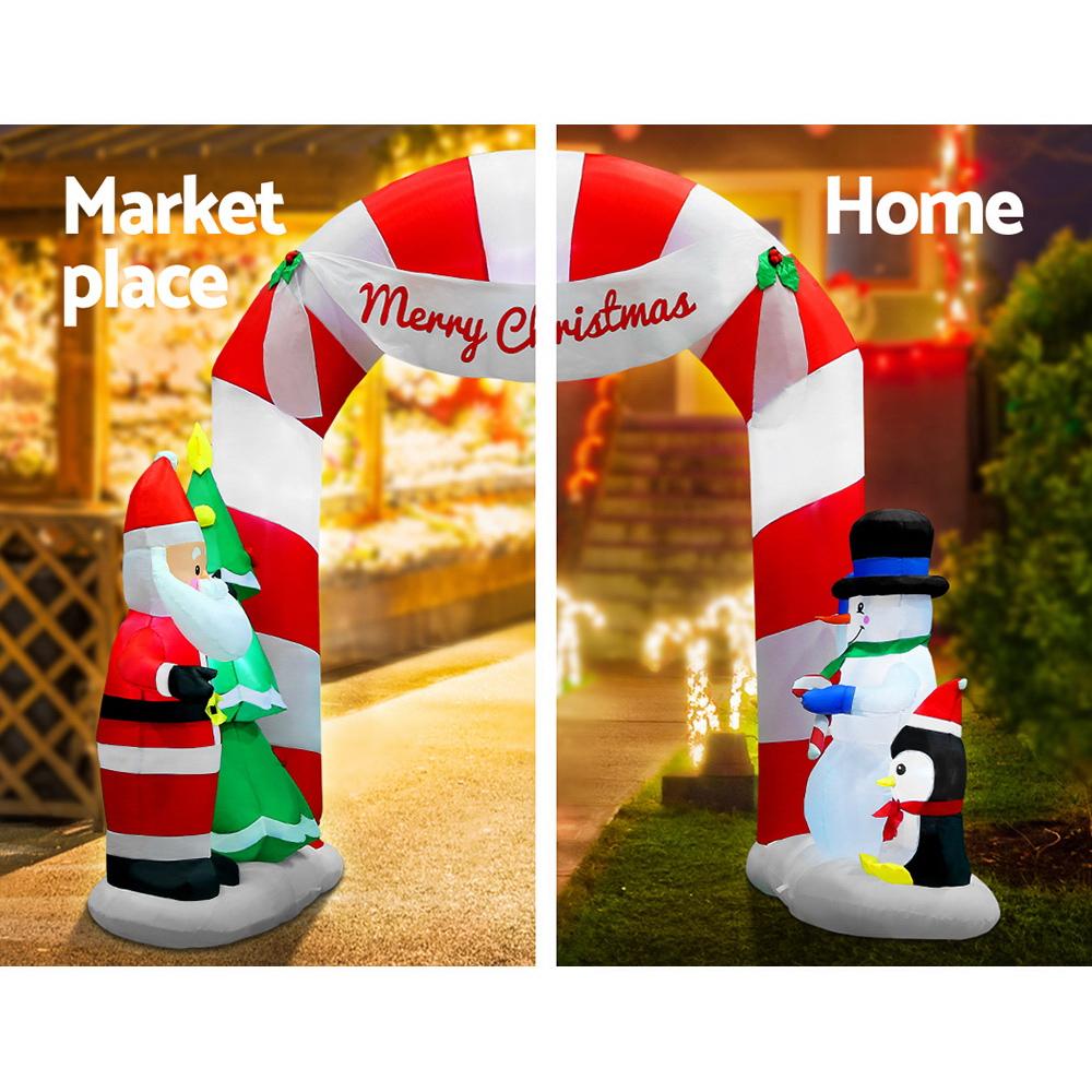 Jingle Jollys 3M Christmas Inflatable Archway featuring Santa, snowman, and penguin, illuminated with LED lights.