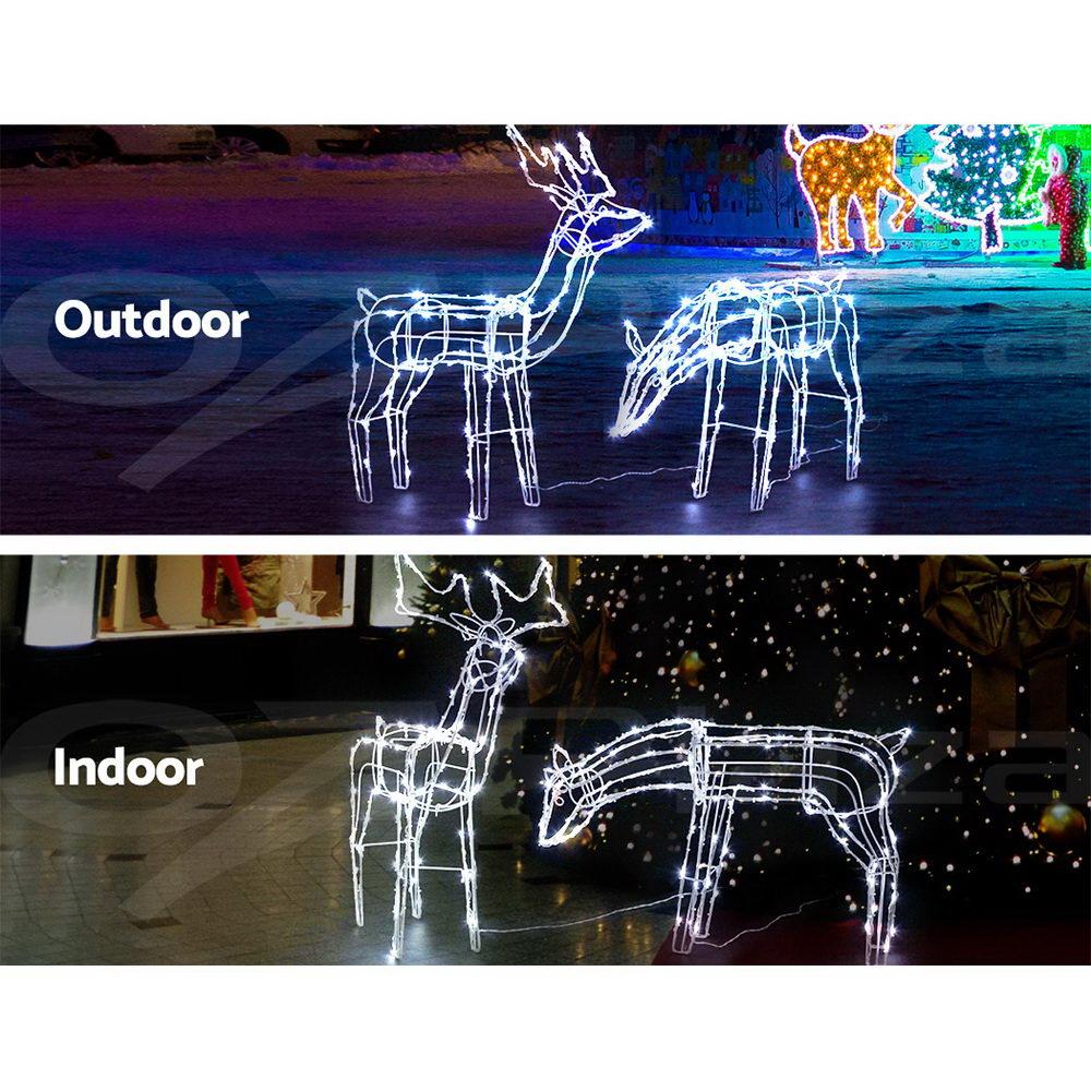 Two LED reindeer lights in feeding and standing positions, illuminated with bright LEDs, set against a snowy background.