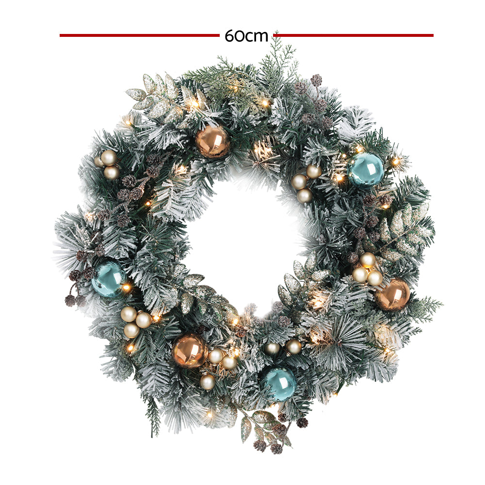 Jingle Jollys 60CM Christmas wreath with pre-lit warm LED lights, featuring thick foliage, pinecones, and decorative balls.