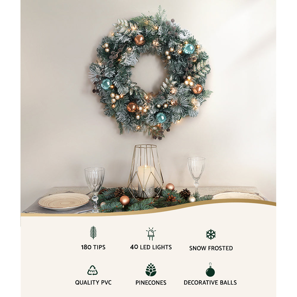 Jingle Jollys 60CM Christmas wreath with pre-lit warm LED lights, featuring thick foliage, pinecones, and decorative balls.