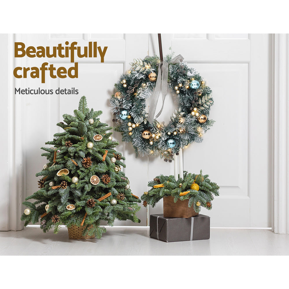 Jingle Jollys 60CM Christmas wreath with pre-lit warm LED lights, featuring thick foliage, pinecones, and decorative balls.