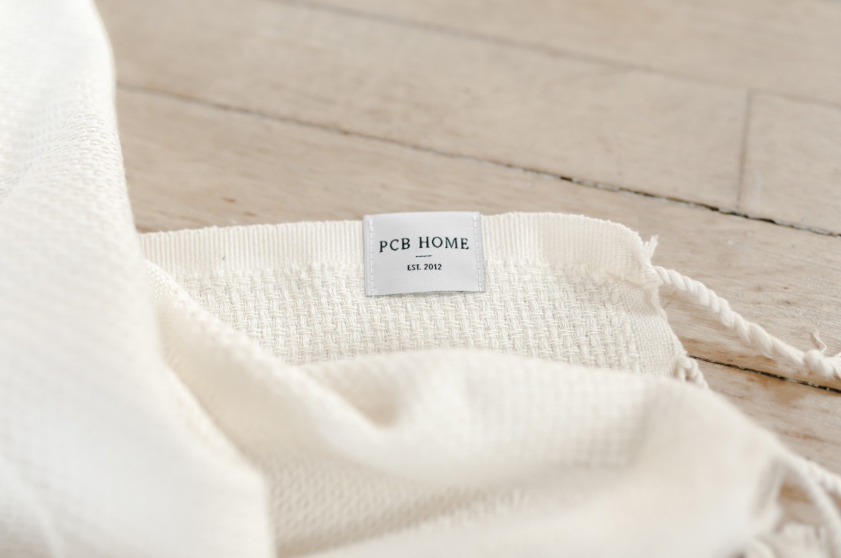 Joy Comes in the Morning Throw Blanket made of 100% organic cotton, featuring a natural unbleached color and elegant design.