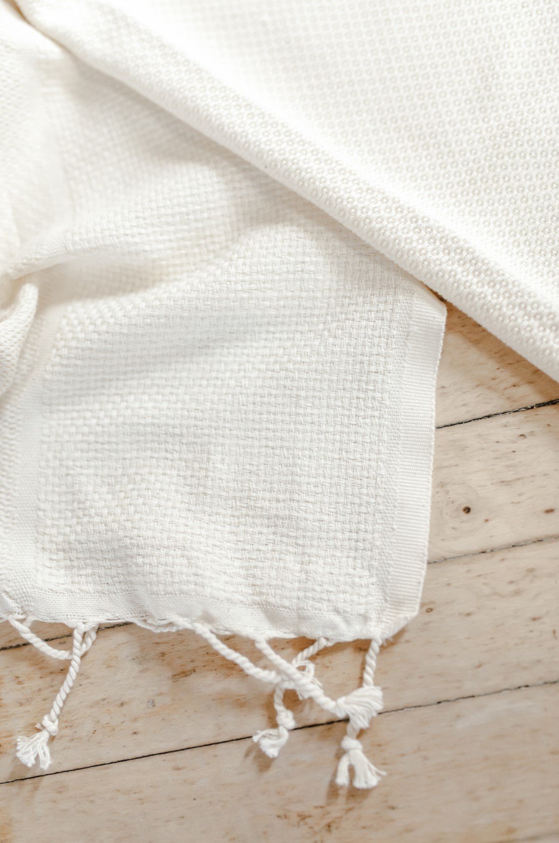 Joy Comes in the Morning Throw Blanket made of 100% organic cotton, featuring a natural unbleached color and elegant design.