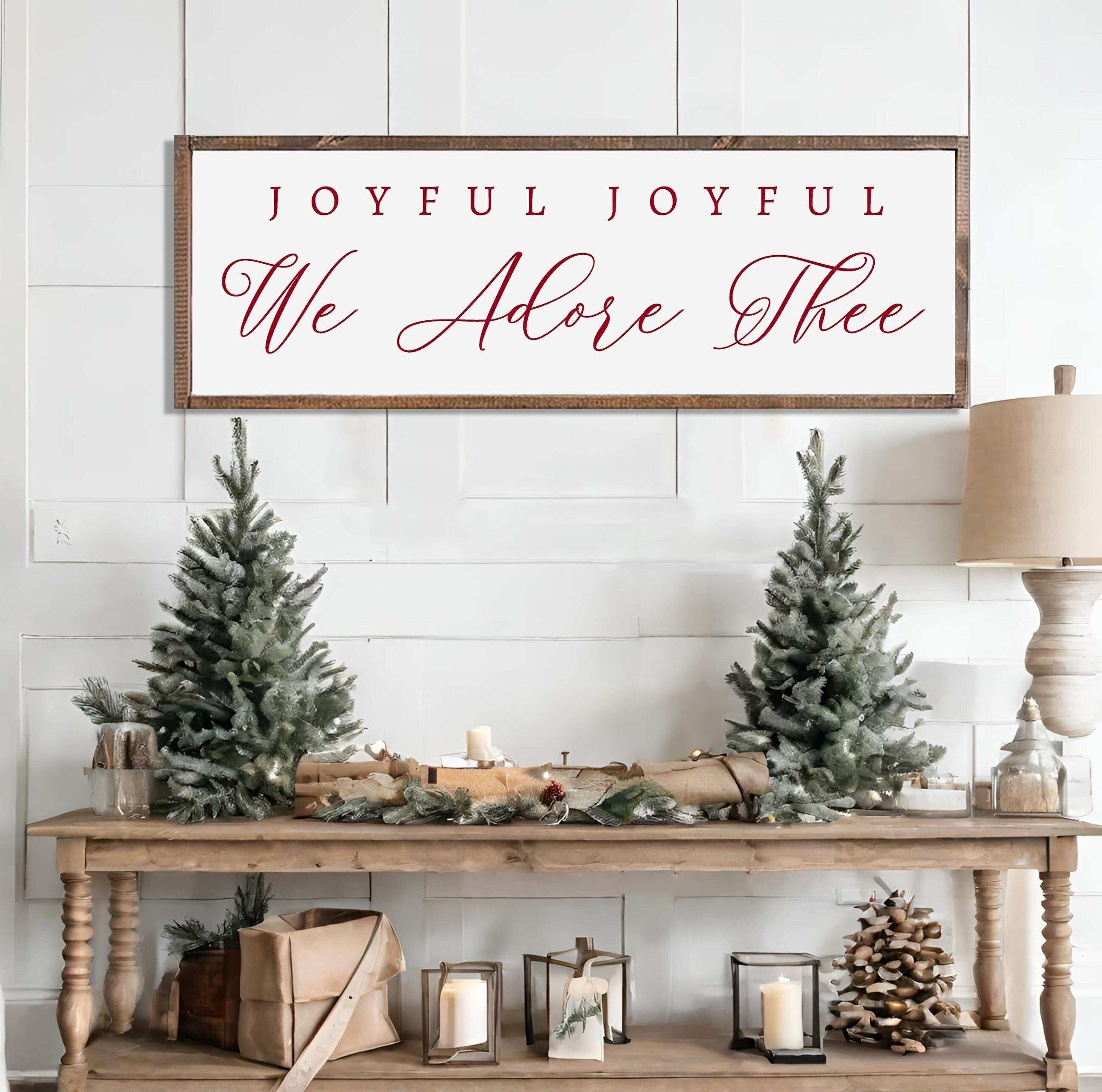 Rustic handmade Christmas wall art featuring the phrase 'Joyful Joyful We Adore Thee' on a dark walnut stained wooden background.