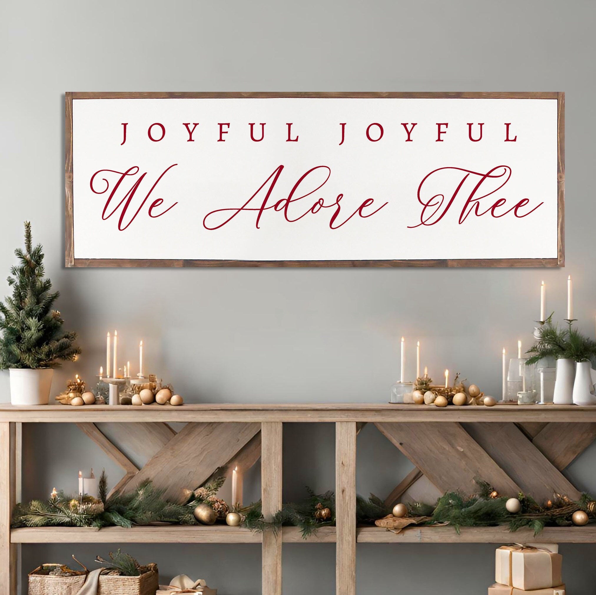 Rustic handmade Christmas wall art featuring the phrase 'Joyful Joyful We Adore Thee' on a dark walnut stained wooden background.