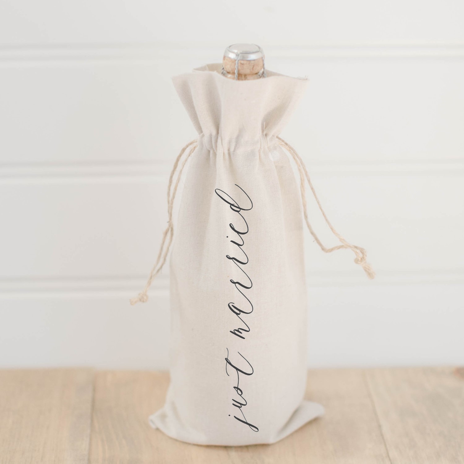 Just Married Wine Bag made of organic linen with twine drawstrings, featuring elegant calligraphy design by Alyssa Thiel.