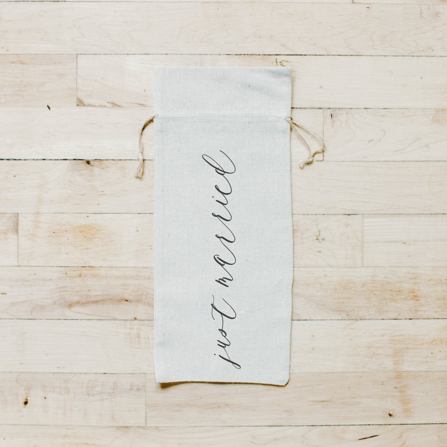 Just Married Wine Bag made of organic linen with twine drawstrings, featuring elegant calligraphy design by Alyssa Thiel.