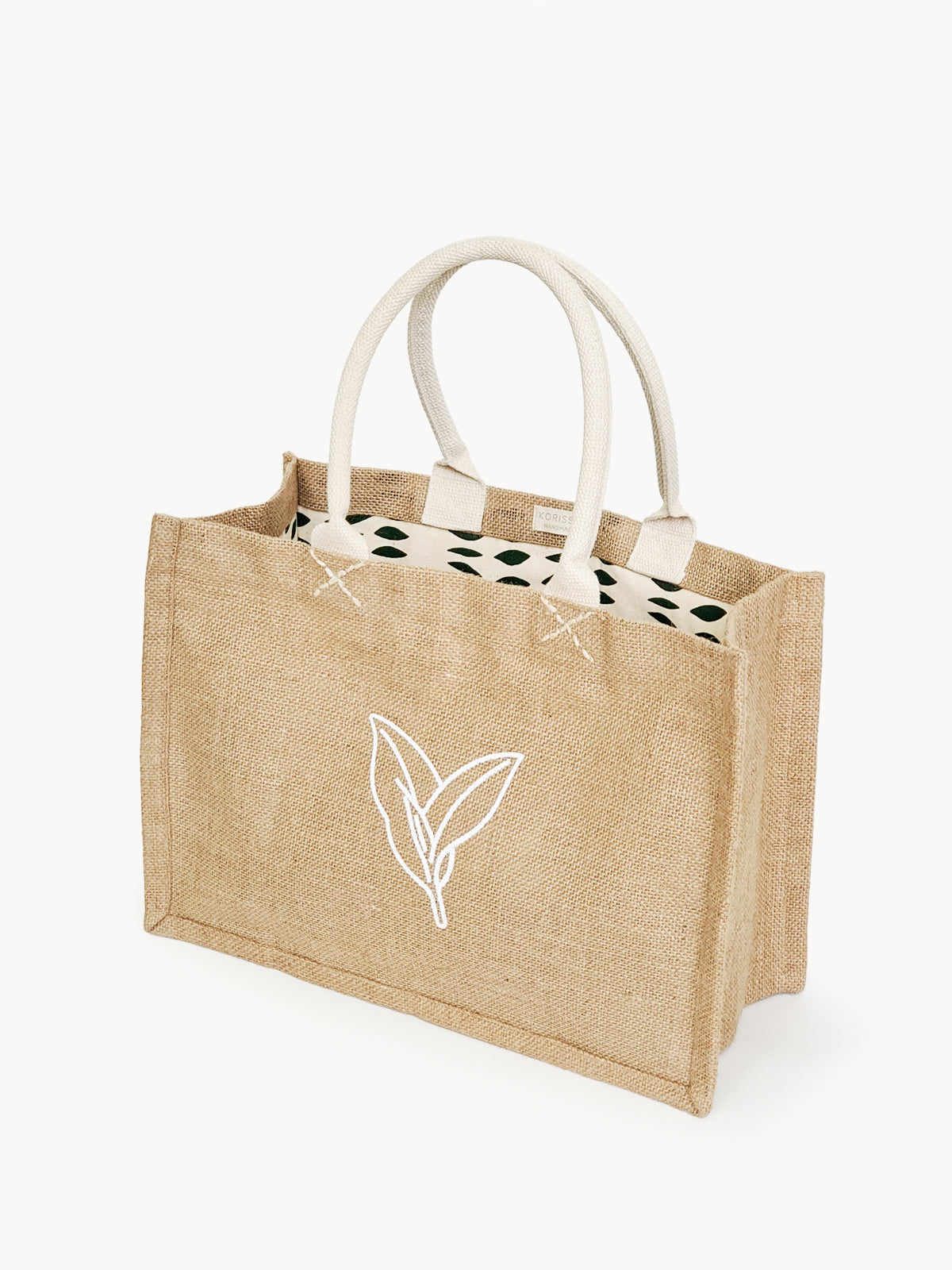 Eco-friendly Jute Canvas Shopping Bag with leaf-patterned canvas lining, showcasing natural burlap fabric.