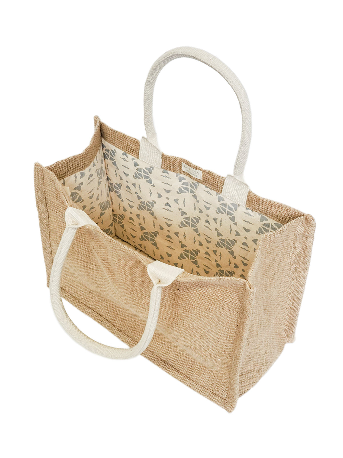 Eco-friendly jute canvas shopping bag with colorful pompom, showcasing its natural texture and spacious design.