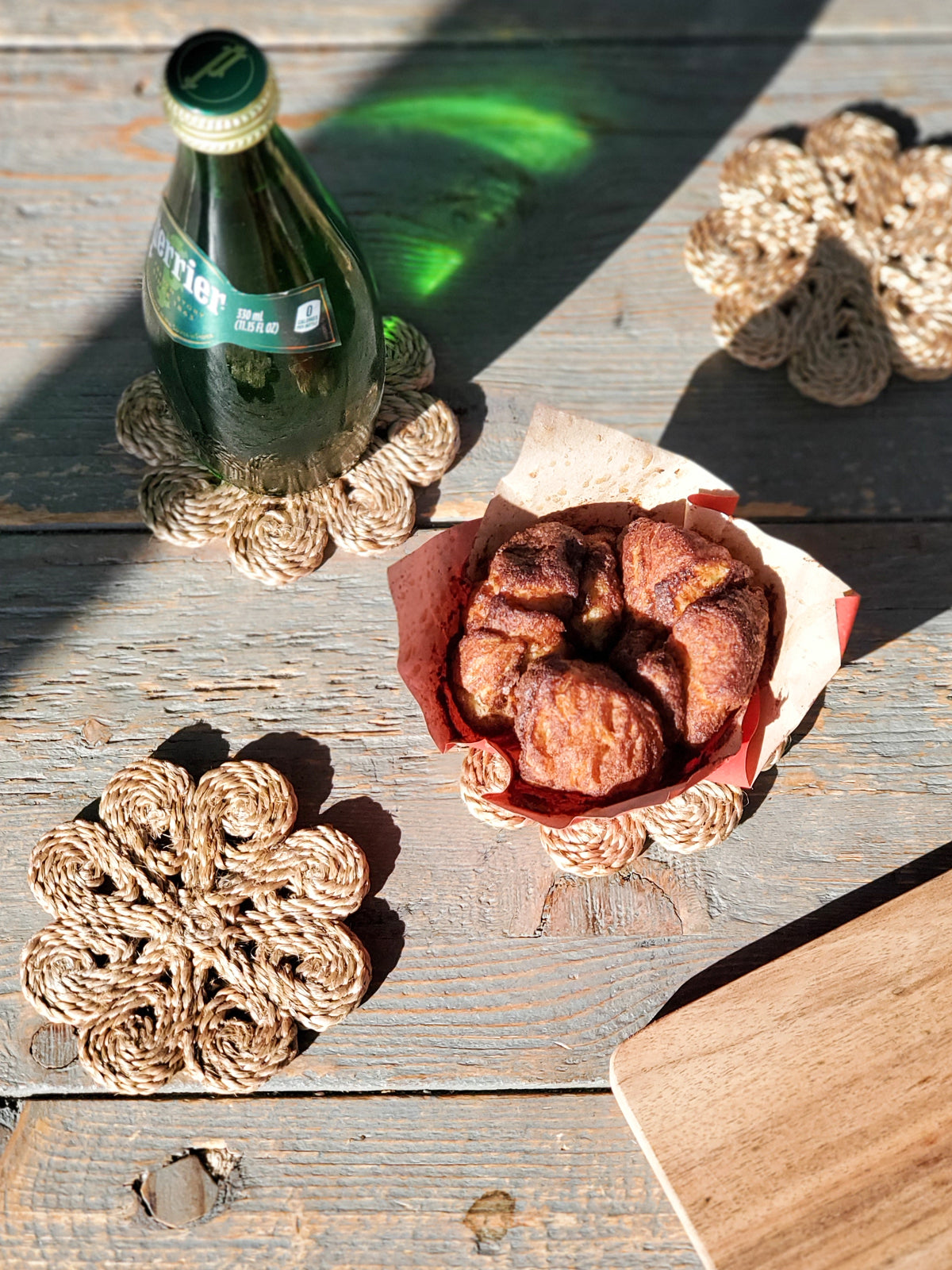 Set of 4 handmade jute flower drink coasters, showcasing natural fiber texture and braided design.