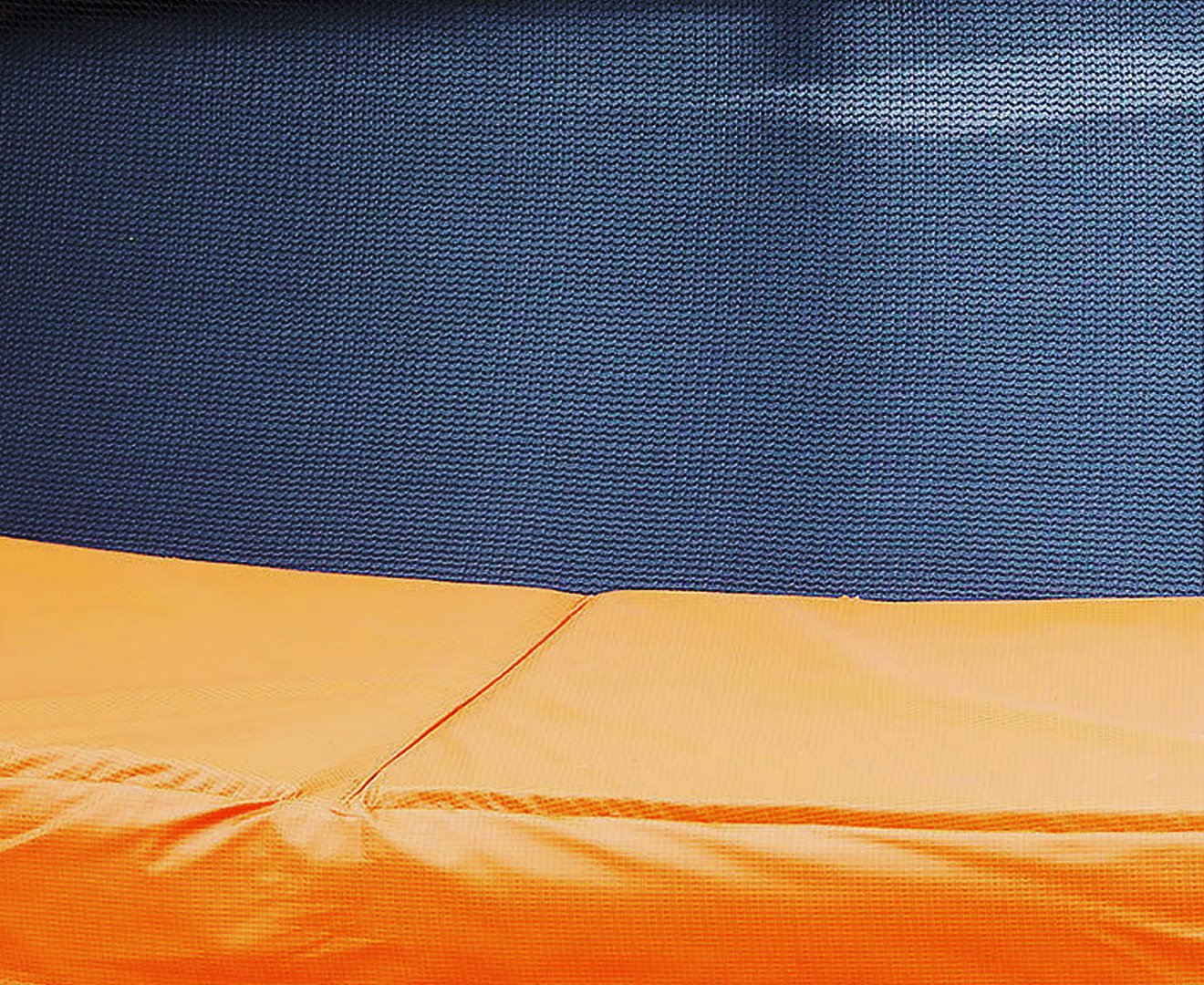 Kahuna 10ft trampoline replacement pad in orange with nylon mesh and PVC skirt, designed for durability and safety.