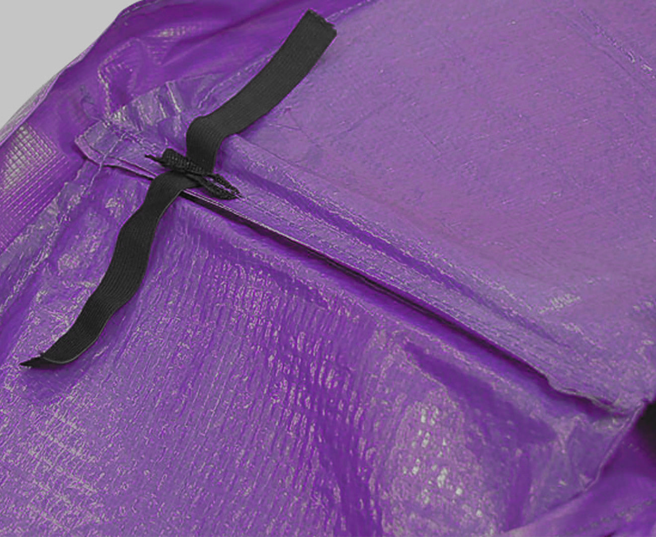 Kahuna 16ft trampoline replacement pad in purple with nylon mesh reinforcement and elastic ties for secure fitting.