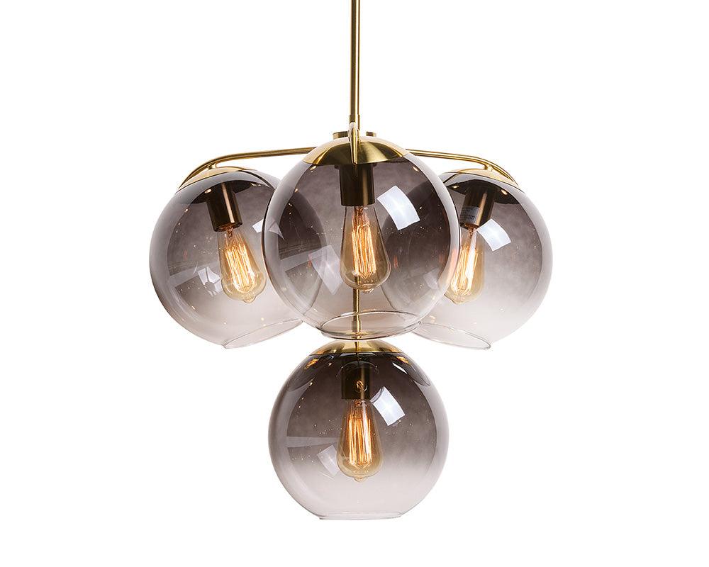 Kamara Chandelier in brass with glass accents, showcasing elegant design and adjustable hanging length.