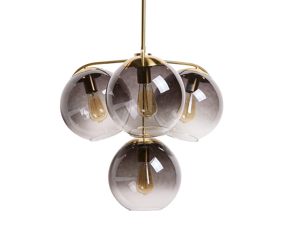 Kamara Chandelier in brass with glass accents, showcasing elegant design and adjustable hanging length.