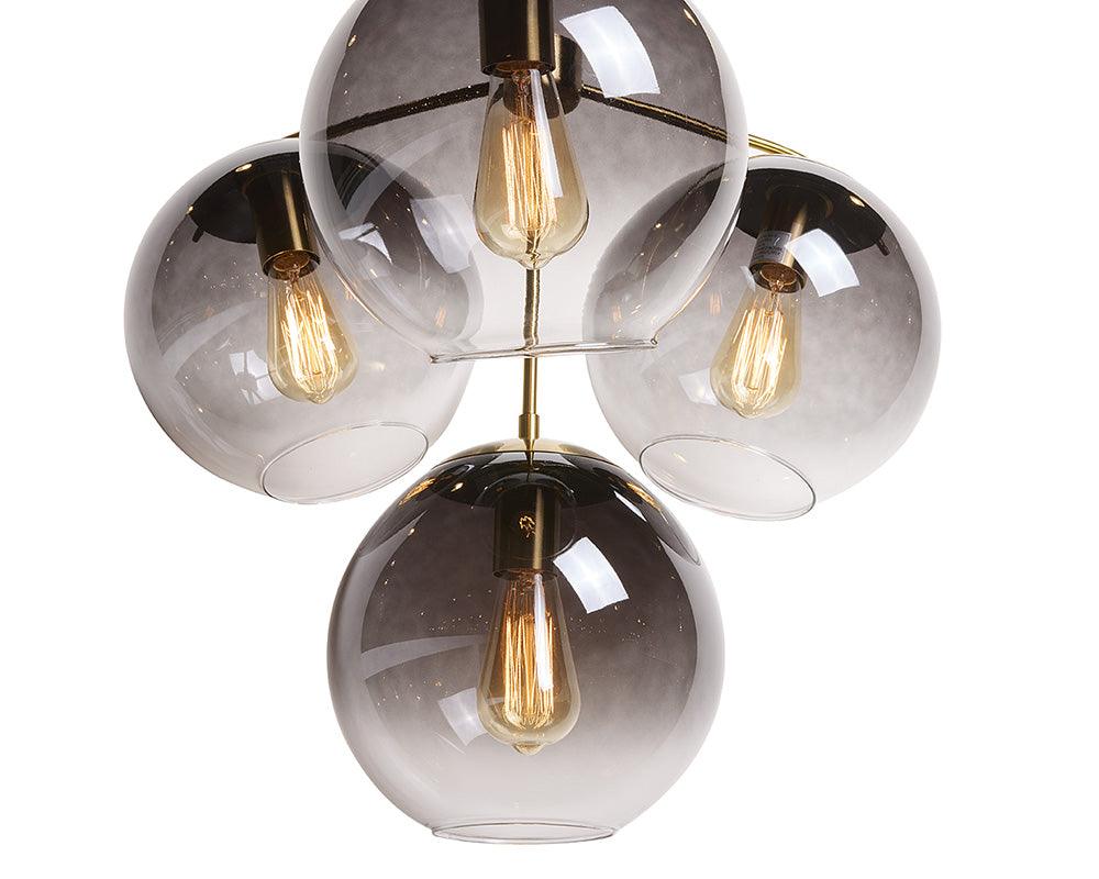 Kamara Chandelier in brass with glass accents, showcasing elegant design and adjustable hanging length.