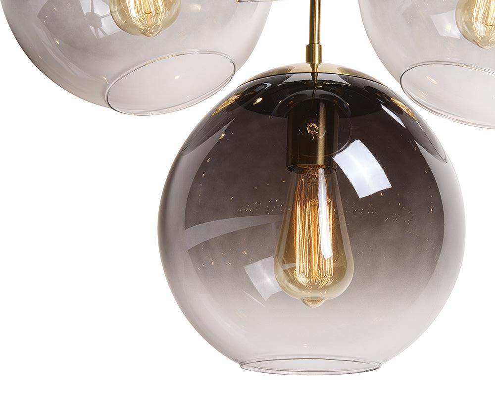 Kamara Chandelier in brass with glass accents, showcasing elegant design and adjustable hanging length.