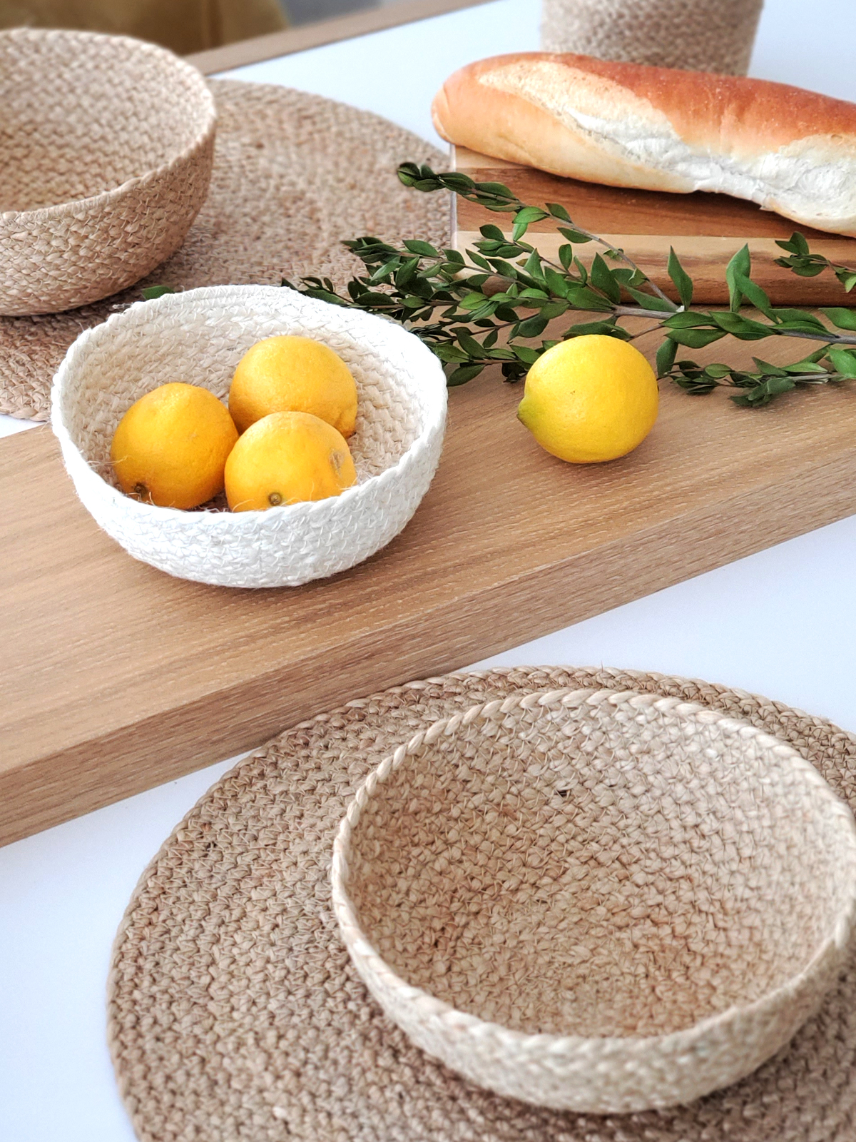 Set of 4 handwoven jute placemats in natural color, perfect for dining tables.