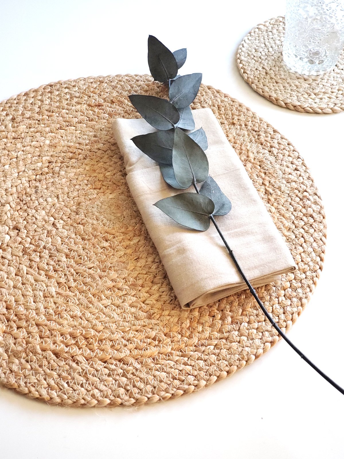 Set of 4 handwoven jute placemats in natural color, perfect for dining tables.