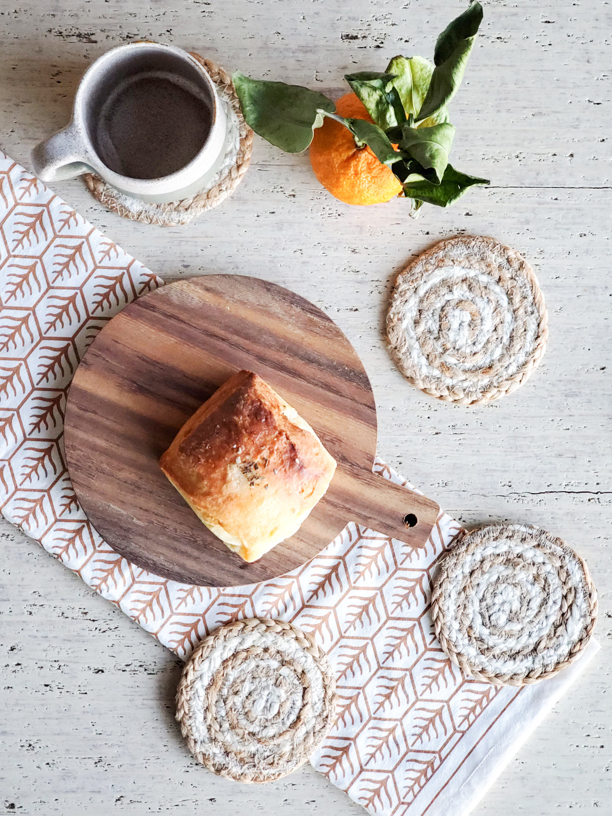 Set of 4 handmade jute drink coasters in natural color, featuring a spiral design, perfect for protecting surfaces.