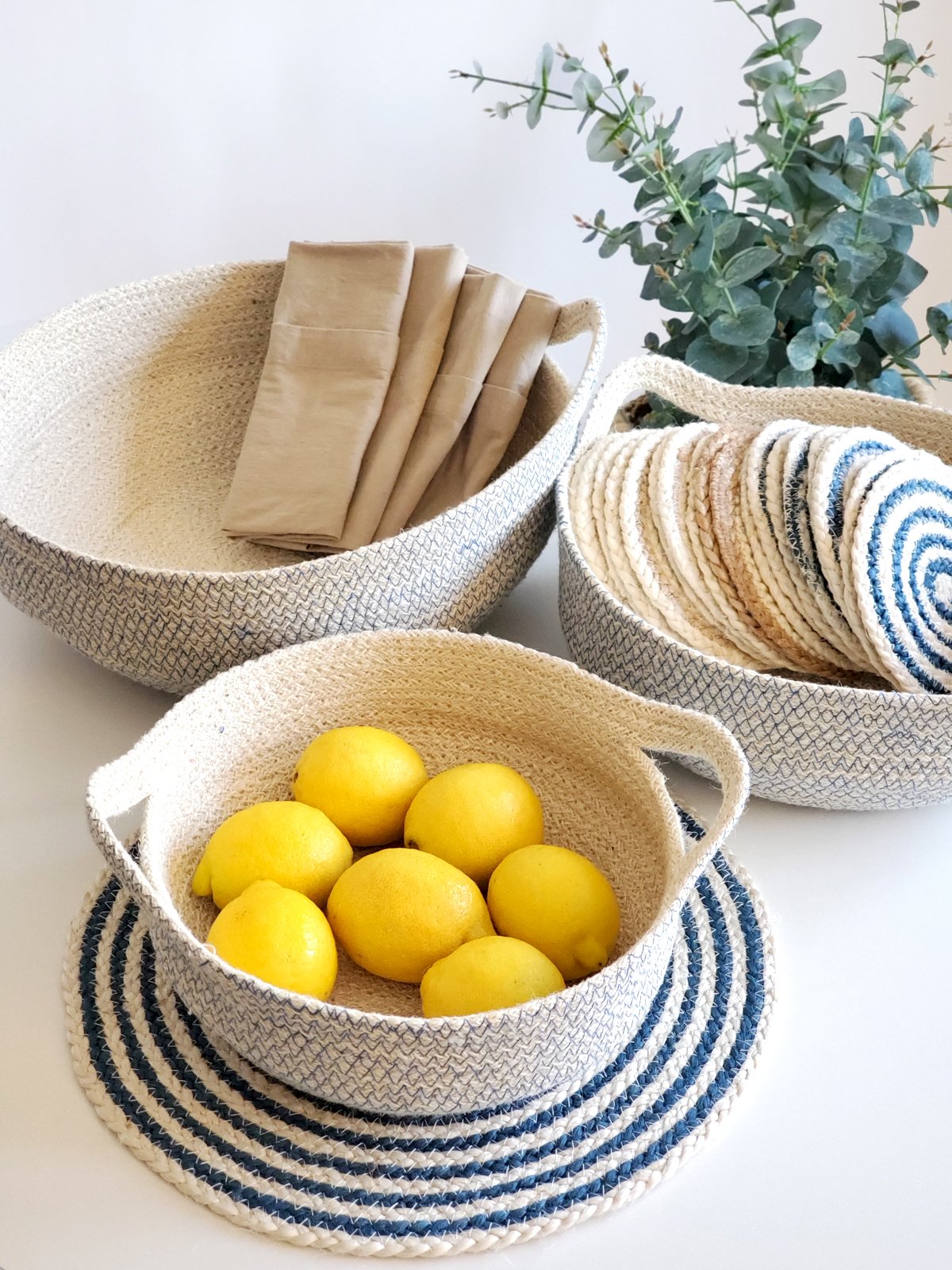 Set of four blue and white round jute placemats, beautifully braided and handcrafted.