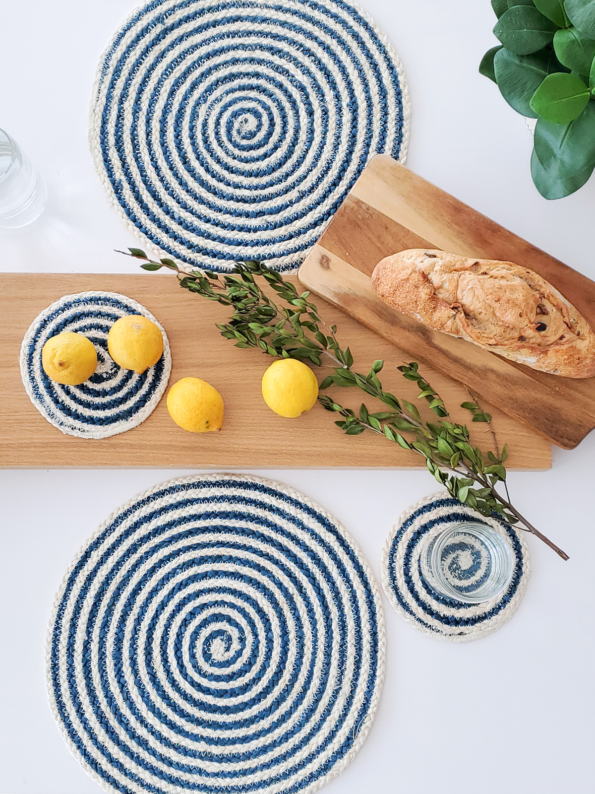 Set of four blue and white round jute placemats, beautifully braided and handcrafted.