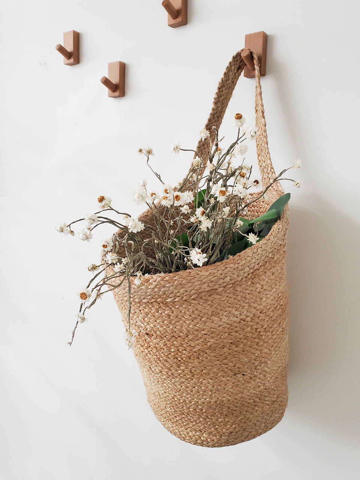 Kata Wall Hanging Basket made from braided jute, showcasing its natural color and unique handcrafted design.