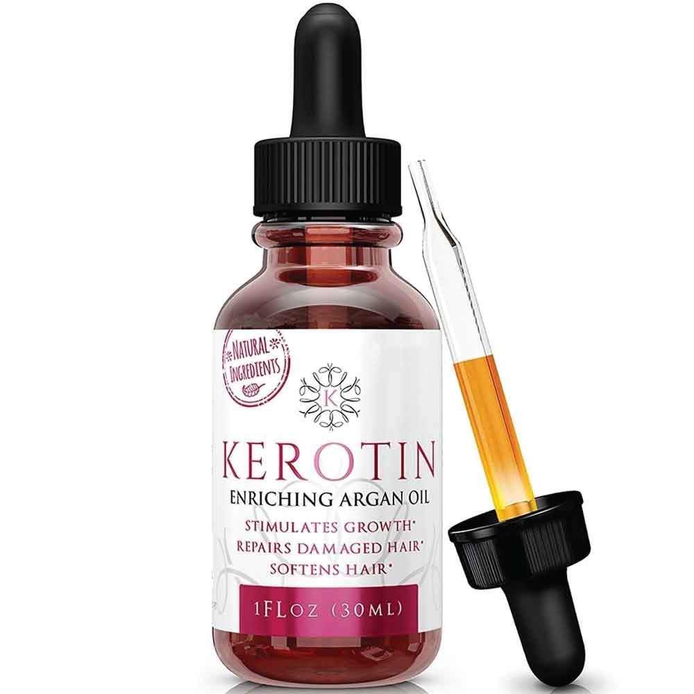 Bottle of Kerotin Enriching Argan Oil with a dropper, showcasing its rich golden color and premium packaging, ideal for hair and skin care.