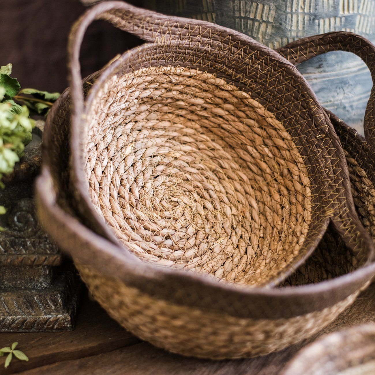 Khaki brown straw basket with handles, showcasing its natural straw texture and elegant design.