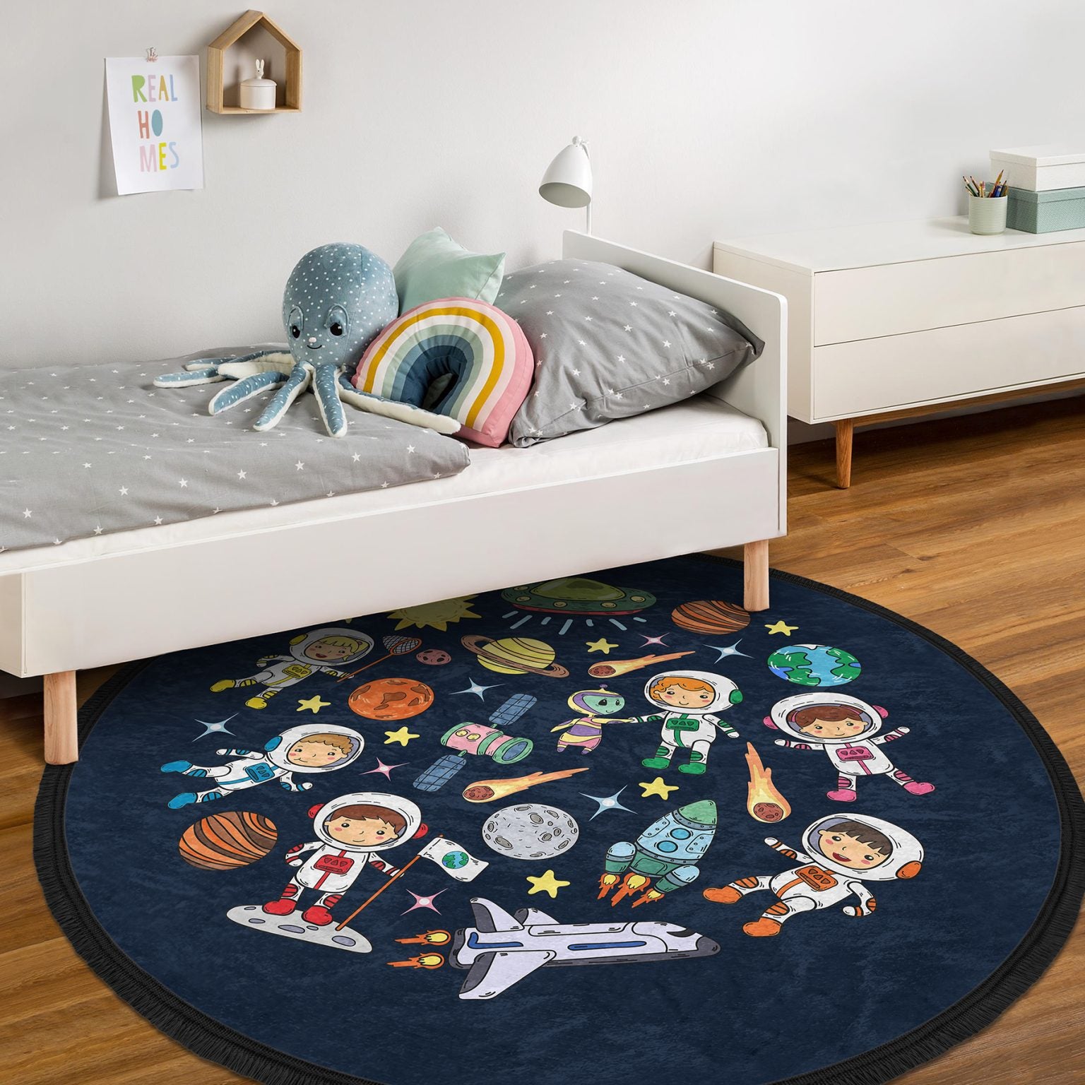 Round kids room area rug with a cute space design, featuring vibrant colors and fringed edges, perfect for nurseries and playrooms.