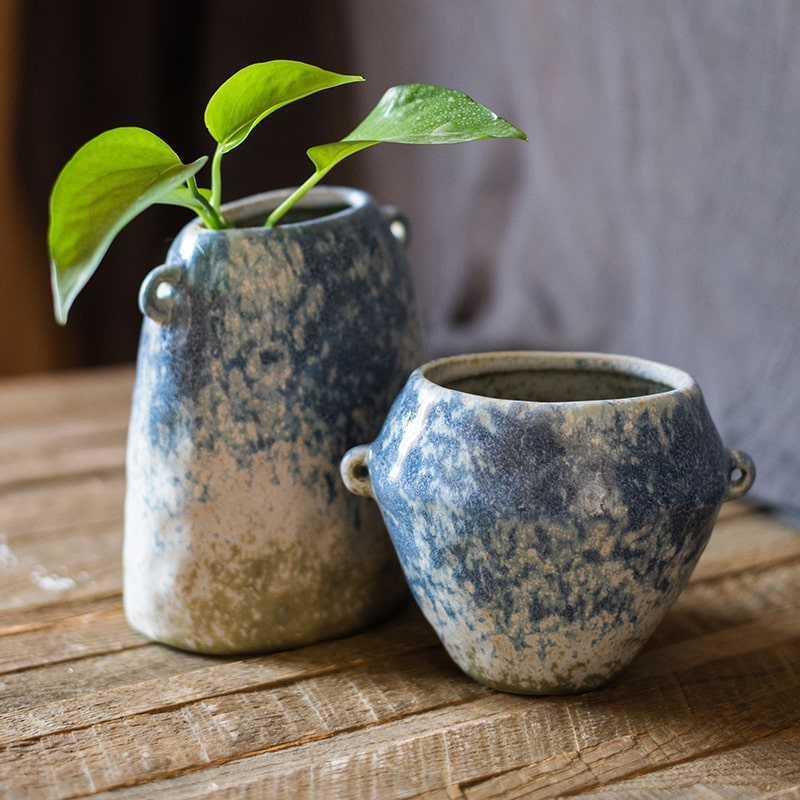 A beautifully handcrafted Kiln Glazed Blue Vase featuring a mix of blue, white, and tan colors, showcasing unique shapes and a glossy finish.