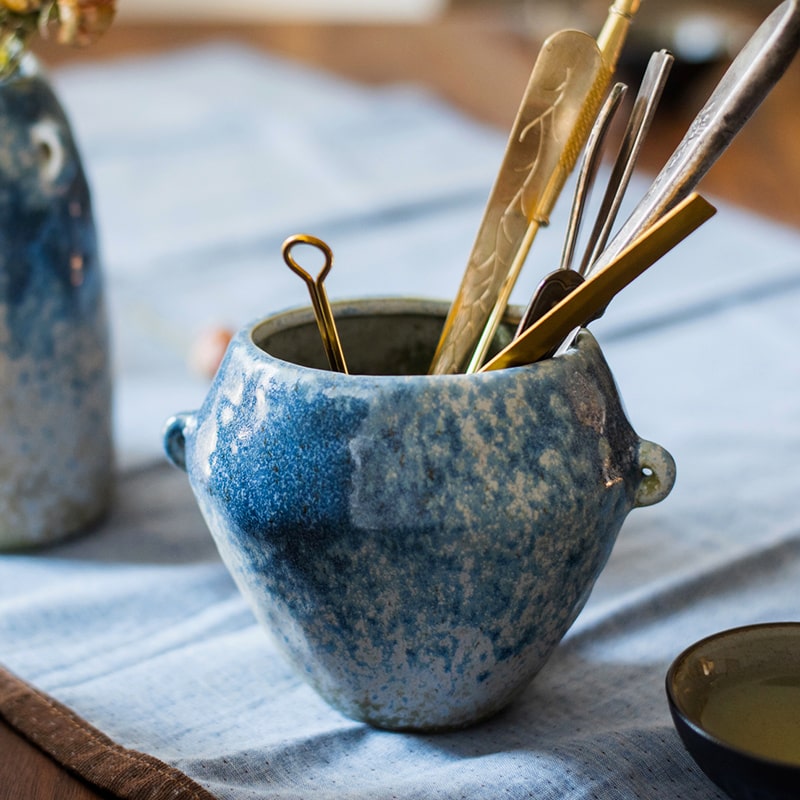 A beautifully handcrafted Kiln Glazed Blue Vase featuring a mix of blue, white, and tan colors, showcasing unique shapes and a glossy finish.