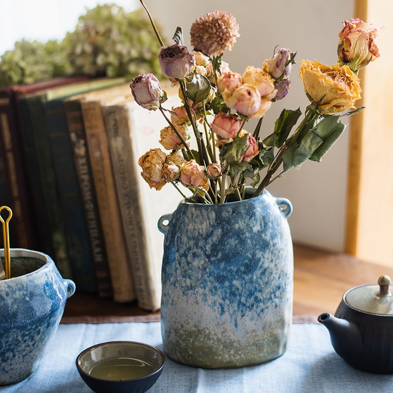 A beautifully handcrafted Kiln Glazed Blue Vase featuring a mix of blue, white, and tan colors, showcasing unique shapes and a glossy finish.