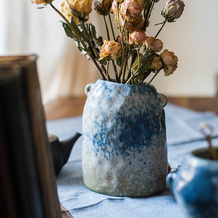 A beautifully handcrafted Kiln Glazed Blue Vase featuring a mix of blue, white, and tan colors, showcasing unique shapes and a glossy finish.