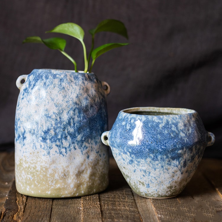 A beautifully handcrafted Kiln Glazed Blue Vase featuring a mix of blue, white, and tan colors, showcasing unique shapes and a glossy finish.