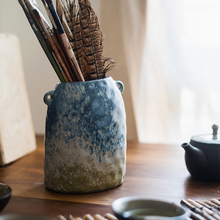 A beautifully handcrafted Kiln Glazed Blue Vase featuring a mix of blue, white, and tan colors, showcasing unique shapes and a glossy finish.