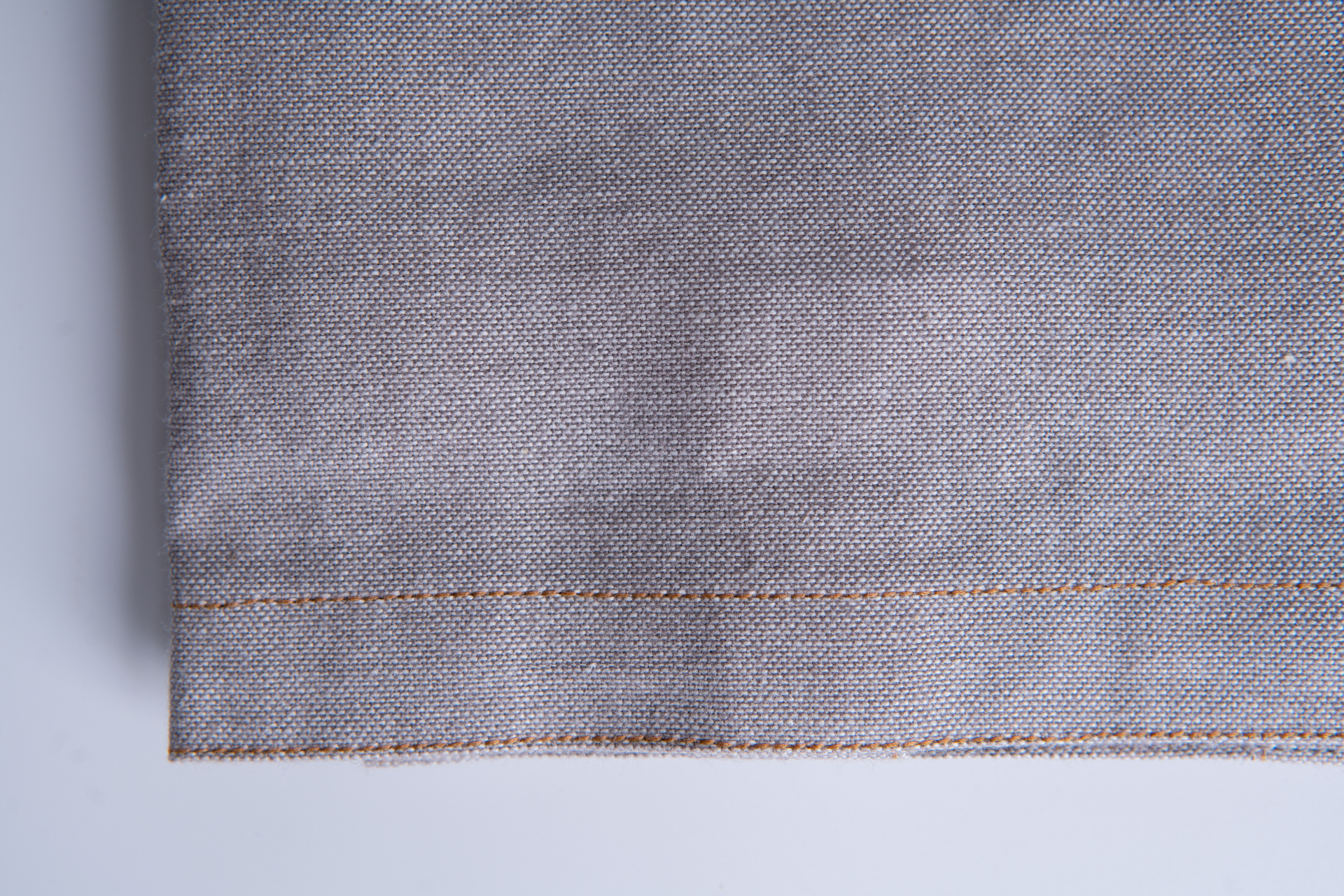 Two grey kitchen towels made of 100% organic cotton with a luxurious chambray weave, elegantly displayed.