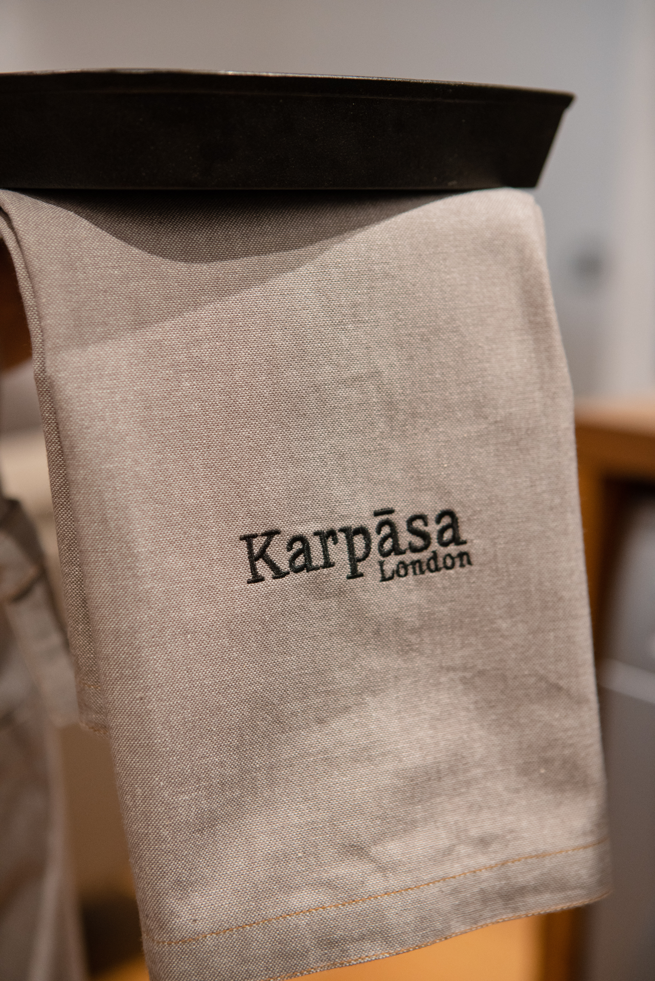 Two grey kitchen towels made of 100% organic cotton with a luxurious chambray weave, elegantly displayed.